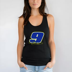 May include: Black tank top featuring a large blue number 9 with a yellow outline and signature. The number is centered on the front of the sleeveless shirt. The tank top is made of a soft, comfortable material.