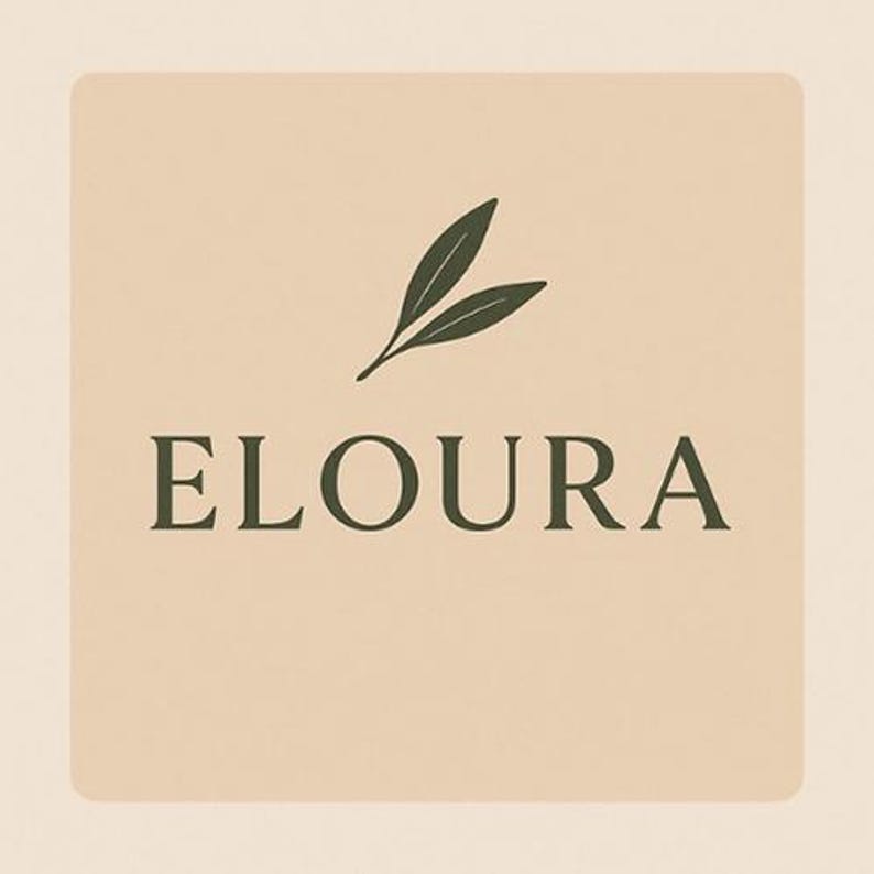 May include: A square logo with the word "ELOURA" in a dark green font. Above the text is a dark green illustration of two leaves. The background is a light beige color.
