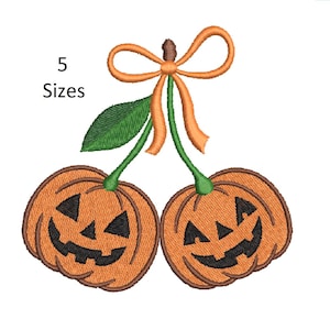 May include: Embroidered design featuring two orange jack-o'-lanterns with black carved faces, connected by green stems, a green leaf, and an orange bow. The text "5 Sizes" is in the upper left corner. A Halloween-themed design.