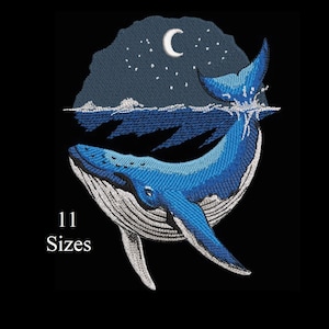 Puede incluir: Diseño bordado de una ballena azul rompiendo el agua bajo un cielo nocturno con una luna creciente y estrellas. El texto "11 Tallas" está debajo de la ballena. El diseño está sobre un fondo negro.