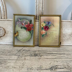 May include: Two framed vintage floral prints. One features orchids and a butterfly with the text "The Best of Mothers." The other print displays colorful flowers and the text "Dear Mother."
