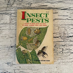 May include: A vintage book titled "Insect Pests: A Guide to More Than 350 Pests of Home, Garden, Field, and Forest." The cover features a colorful illustration of various insects on a green leaf. The book is a Golden Nature Guide.