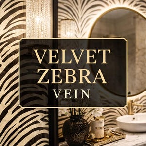 May include: A bathroom featuring zebra print wallpaper and a gold-framed mirror. A black sign with the words "VELVET ZEBRA VEIN" is in the foreground. The sink and fixtures are gold-toned, and a black vase holds white flowers.