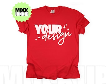 May include: A red t-shirt with the words "YOUR design" in white script. The design includes white starbursts. The shirt is a mock-up, perfect for showcasing custom designs.