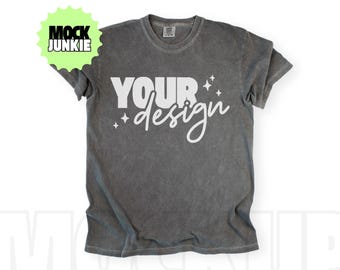 May include: A gray t-shirt with the words "YOUR design" in white script. The shirt has a vintage, washed look. The words are accented with small starbursts. A green and yellow sticker in the upper left corner reads "MOCK JUNKIE".