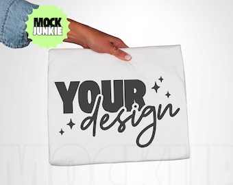 May include: A white pillowcase with the words "YOUR design" in black script and block letters. The pillowcase is held by a hand. The image also includes a green and yellow logo that says "MOCK JUNKIE".