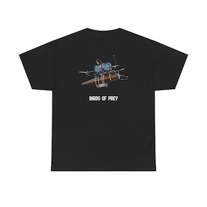 May include: Black t-shirt featuring a detailed graphic of a drone with blue, brown, and silver components. The text "BIRDS OF PREY" is printed in white below the drone image. The shirt is made of a soft, comfortable material.