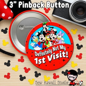 May include: A 7.6 cm pinback button with a red background and the text "Definitely Not My 1st Visit!" features Mickey Mouse, Minnie Mouse, Donald Duck, Daisy Duck, and Goofy. Mickey Mouse-shaped confetti surrounds the button.