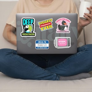 May include: A laptop covered in colorful stickers. The stickers feature phrases like "DEEP PROCRASTINATION", "BIGGEST PROCRASTINATOR EVER", and "HONK IF YOU AGREE I'M OVERQUALIFIED". Other stickers say "HELLO, I'M PROBABLY LATE BUT I BROUGHT SNACKS" and "BUFERBING".