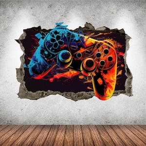 Puede incluir: Un adhesivo de pared con una ilustración abstracta y vibrante de un mando de videojuegos. El diseño utiliza una paleta de colores de alto contraste en azul brillante, naranja y rojo, creando un efecto 3D como si el mando atravesara la pared.