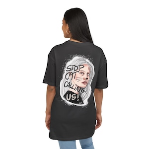 May include: A white ceramic mug with a black handle and the text "But First, Coffee" in a bold, black font. The mug is set against a blurred background, suggesting a cozy setting.