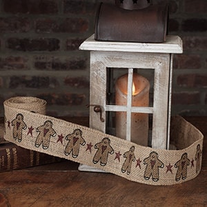 May include: Brown burlap ribbon with a repeating pattern of gingerbread men and red stars.