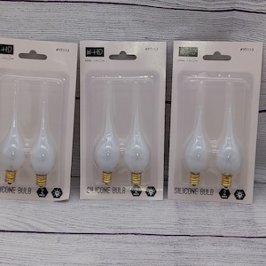 May include: Three packages of white silicone light bulbs. Each package contains two bulbs and has the text "W-HD" and "SILICONE BULB" printed on it.