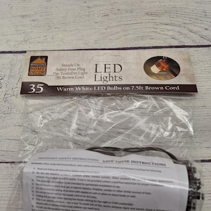 May include: A package of LED lights with 35 warm white bulbs on a 7.5ft brown cord. The packaging includes the text "LED Lights" and "Warm White LED Bulbs". The package also includes safety instructions.
