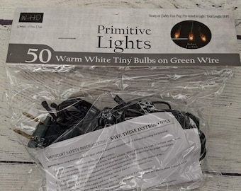 May include: A package of "Primitive Lights" with 50 warm white tiny bulbs on green wire. The package includes a safety fuse plug and is pre-tested to light. Total length is 10 feet.