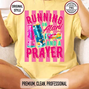May include: Yellow t-shirt featuring the text "RUNNING ON Alani AND A PRAYER" in pink and green, with illustrations of Alani energy drink cans. The shirt also has the text "ORIGINAL STYLE" and "PREMIUM, CLEAN, PROFESSIONAL".