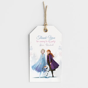 May include: A white gift tag with a string, featuring a watercolor illustration of two characters and a snowman. The tag reads "Thank You for coming to my party! Love, Rachel."