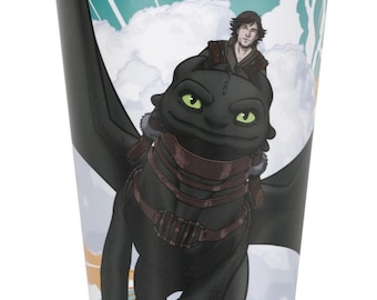 May include: A white-rimmed paper cup featuring a cartoon image of a black dragon with green eyes and a person riding on its back. The background has a cloudy sky design with teal and orange accents. The cup is designed for beverages.