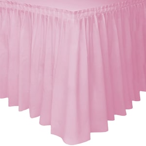 May include: A light pink bed skirt with a pleated design. The fabric is gathered at the top and falls in soft, vertical folds. The skirt has a scalloped hemline, adding a decorative touch to the bed's base.