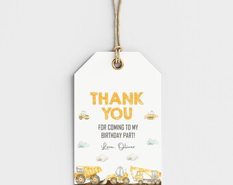 May include: White gift tag with the text "THANK YOU" in gold glitter font. The tag includes the message "FOR COMING TO MY BIRTHDAY PART! Love, Oliver." and illustrations of construction vehicles.