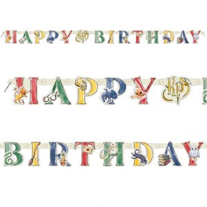 May include: A colorful "Happy Birthday" banner with letters in various colors, featuring themed illustrations. The banner includes images of a lion, glasses, a golden snitch, a hat, and an owl. The banner is strung on a white ribbon.