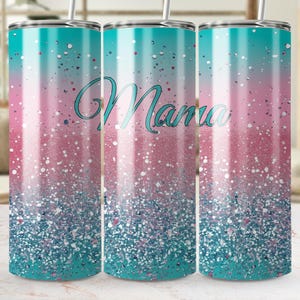 May include: A stainless steel tumbler with a gradient design of teal, pink, and white glitter. The word "Mama" is written in a teal script across the front. The tumbler includes a straw.