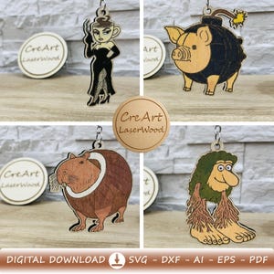 Peut inclure: Plusieurs porte-clés en bois découpés au laser avec des motifs originaux. Ils représentent une femme avec une tête de tasse à café, un cochon en forme de bombe, un capybara et une créature ressemblant à un troll. Le texte "CreArt LaserWood" est visible.