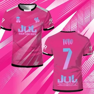 May include: A short-sleeve t-shirt in bright pink with black trim on the collar and sleeves. The front features an alien graphic, the text JUL RIEN 100 RIEN, and a logo. The back displays the name TOTO, the number 7, and the text JUL.