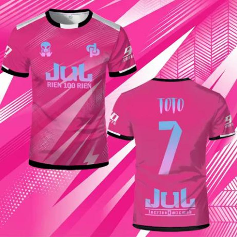 May include: A short-sleeve t-shirt in bright pink with black trim on the collar and sleeves. The front features an alien graphic, the text JUL RIEN 100 RIEN, and a logo. The back displays the name TOTO, the number 7, and the text JUL.