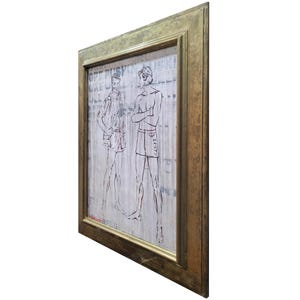 May include: A framed artwork featuring a black and white illustration of two men in swim trunks. The artwork is set against a background of printed text.