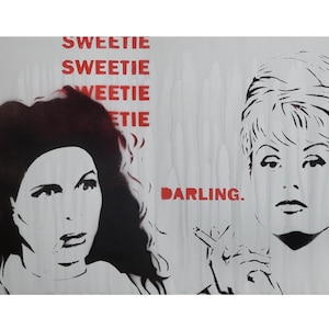 May include: Stencil art print featuring two women's faces in black and white, with the words "SWEETIE" and "DARLING" in red. One woman is smoking a cigarette.