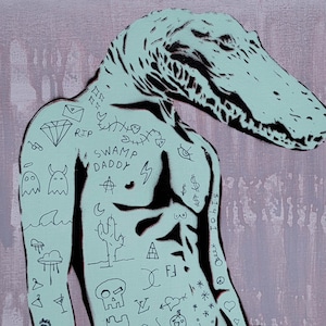 May include: A pop art style painting of a muscular figure with an alligator head. The figure is light blue with black tattoos, including the words "SWAMP DADDY" and various symbols. The background is a muted pink.