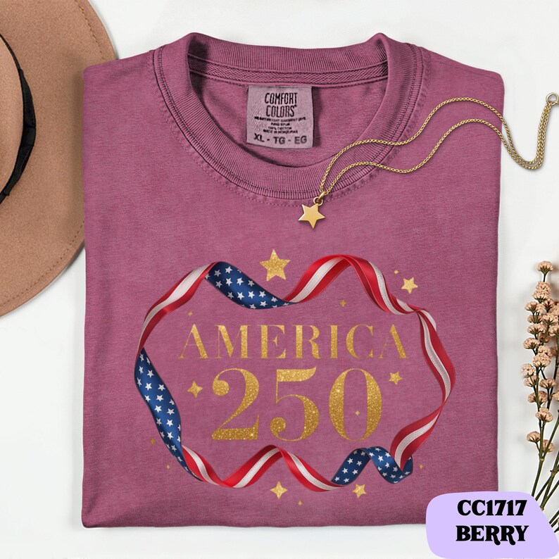 Bold gold glitter style America 250 typography framed with flowing USA flag ribbon and stars. Printed on soft premium cotton tees for adults, youth and toddlers. Unisex relaxed fit, breathable and durable for all day comfort. Ideal for Independence Day, patriotic parades, fireworks nights, family matching outfits, USA 250 celebrations and summer events.