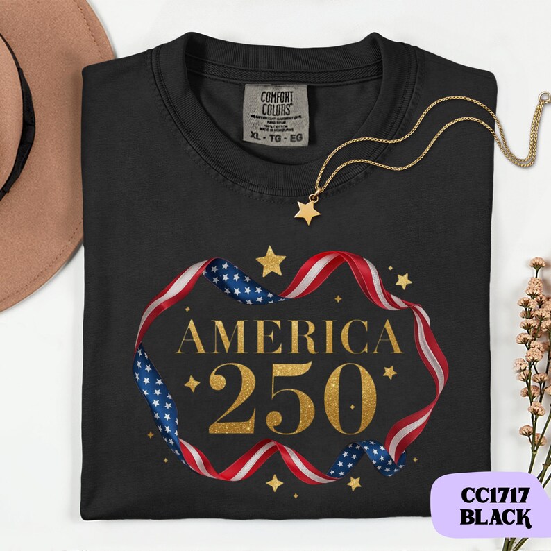 Bold gold glitter style America 250 typography framed with flowing USA flag ribbon and stars. Printed on soft premium cotton tees for adults, youth and toddlers. Unisex relaxed fit, breathable and durable for all day comfort. Ideal for Independence Day, patriotic parades, fireworks nights, family matching outfits, USA 250 celebrations and summer events.