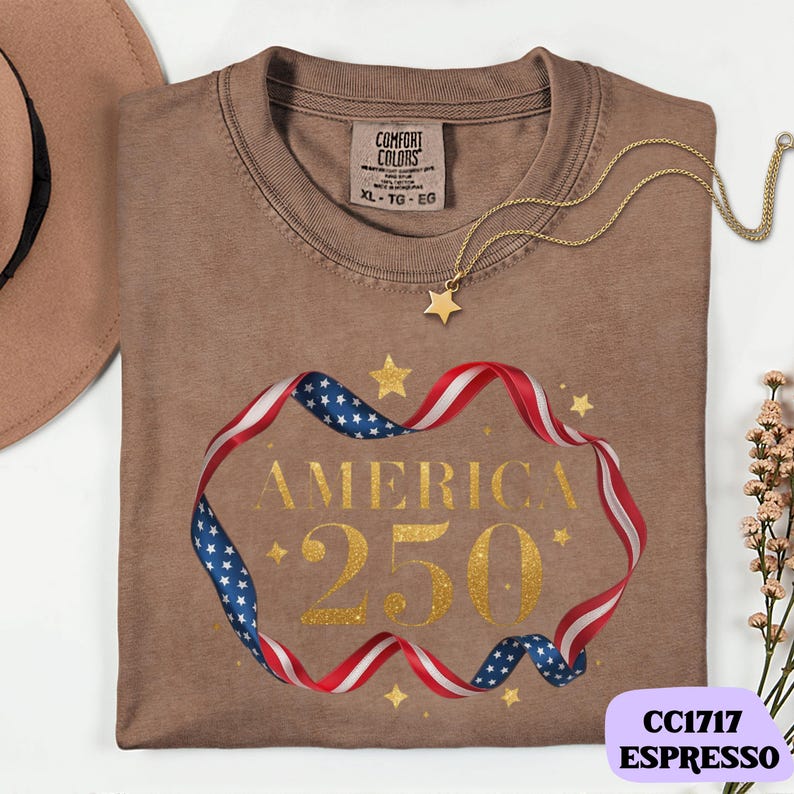 Bold gold glitter style America 250 typography framed with flowing USA flag ribbon and stars. Printed on soft premium cotton tees for adults, youth and toddlers. Unisex relaxed fit, breathable and durable for all day comfort. Ideal for Independence Day, patriotic parades, fireworks nights, family matching outfits, USA 250 celebrations and summer events.