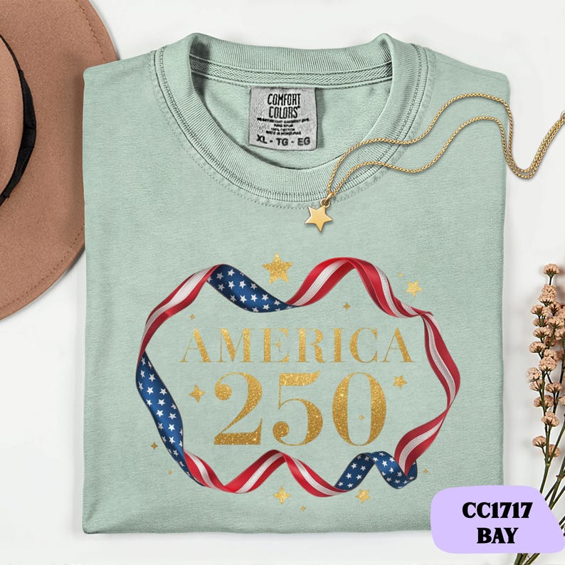 Bold gold glitter style America 250 typography framed with flowing USA flag ribbon and stars. Printed on soft premium cotton tees for adults, youth and toddlers. Unisex relaxed fit, breathable and durable for all day comfort. Ideal for Independence Day, patriotic parades, fireworks nights, family matching outfits, USA 250 celebrations and summer events.