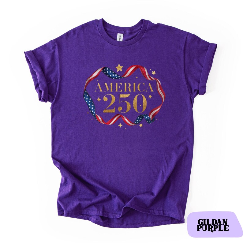 Bold gold glitter style America 250 typography framed with flowing USA flag ribbon and stars. Printed on soft premium cotton tees for adults, youth and toddlers. Unisex relaxed fit, breathable and durable for all day comfort. Ideal for Independence Day, patriotic parades, fireworks nights, family matching outfits, USA 250 celebrations and summer events.