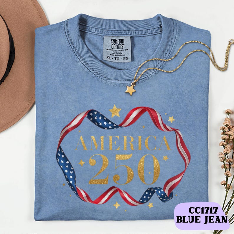 Bold gold glitter style America 250 typography framed with flowing USA flag ribbon and stars. Printed on soft premium cotton tees for adults, youth and toddlers. Unisex relaxed fit, breathable and durable for all day comfort. Ideal for Independence Day, patriotic parades, fireworks nights, family matching outfits, USA 250 celebrations and summer events.
