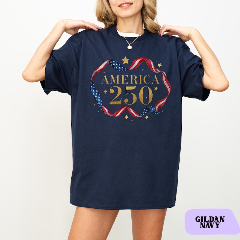 Bold gold glitter style America 250 typography framed with flowing USA flag ribbon and stars. Printed on soft premium cotton tees for adults, youth and toddlers. Unisex relaxed fit, breathable and durable for all day comfort. Ideal for Independence Day, patriotic parades, fireworks nights, family matching outfits, USA 250 celebrations and summer events.