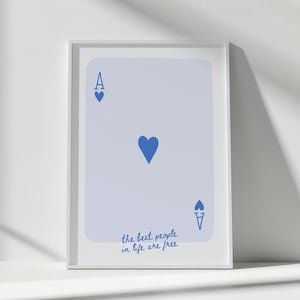 May include: Framed print of the Ace of Hearts playing card in light blue with blue heart symbols. The text "the best people in life are free" is written in blue script at the bottom of the card.