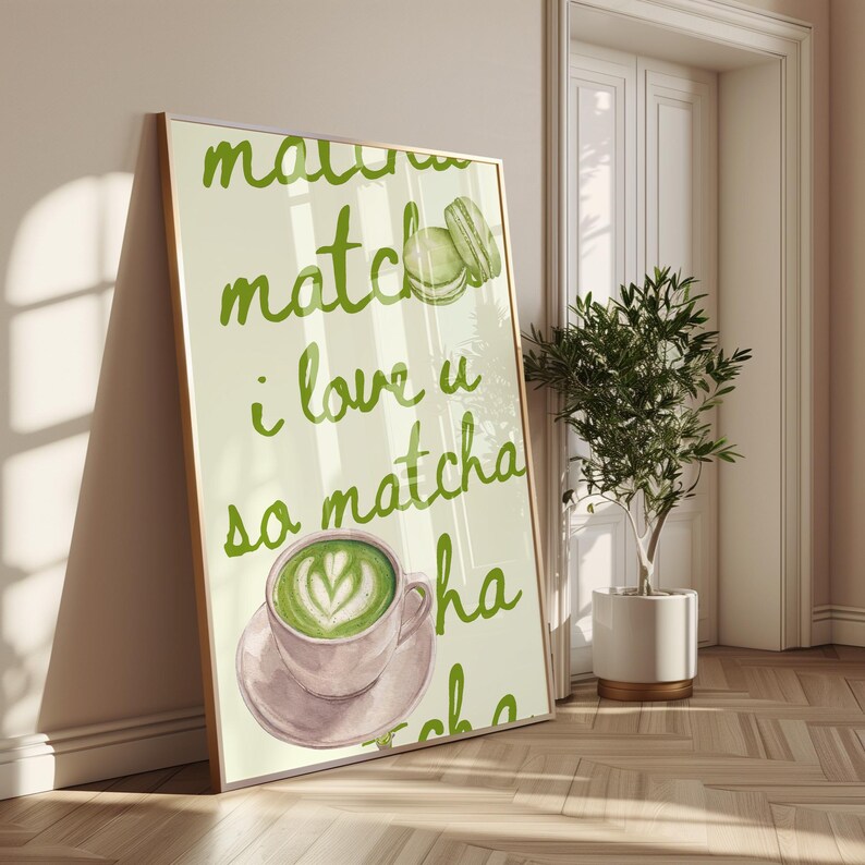 May include: A framed art print with a watercolor illustration. The artwork features the words "matcha, i love u so matcha" in green script, a cup of matcha latte with heart-shaped foam art, and two green macarons.