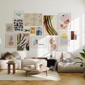 May include: A collection of framed art prints in various sizes and styles, including abstract shapes, botanical illustrations, and geometric patterns. The color palette includes earth tones, black, white, and pops of color, creating a modern and artistic display.