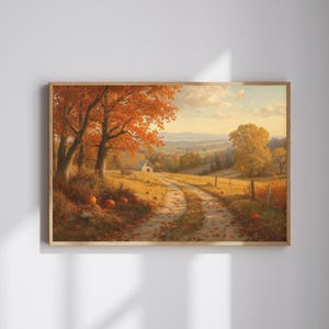 Puede incluir: Pintura de paisaje enmarcada que representa una escena otoñal. Un camino de tierra serpentea a través de un campo, pasando por árboles con hojas naranjas y calabazas. Una pequeña casa blanca es visible en la distancia bajo un cielo azul.