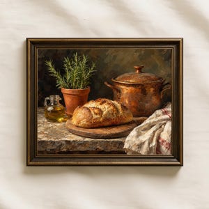 May include: A framed still life painting featuring a loaf of crusty bread on a wooden board, a copper pot with a lid, a small terracotta pot with green rosemary, a glass cruet of olive oil, and a white cloth with red stripes on a stone surface.