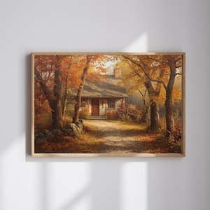 Puede incluir: Una impresión enmarcada de una pintoresca cabaña en un vibrante paisaje otoñal. La obra de arte presenta un camino que conduce a la cabaña, enmarcado por árboles con follaje naranja y amarillo. Un muro de piedra bordea el camino, realzando el encanto rústico.
