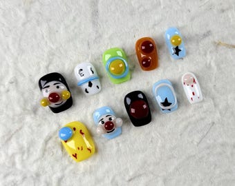 Short Square Press On Nails with Fun Patterns. Black with Red Nose, White with Black Lines, Blue with Stars. Creative, Quirky Design