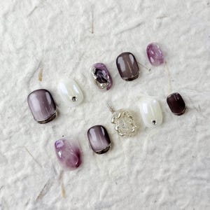 Bold Square Press On Nails with Purple & White Shades, Shimmering Rhinestones, and Metallic Lines, Perfect for Fashion-Forward Individuals