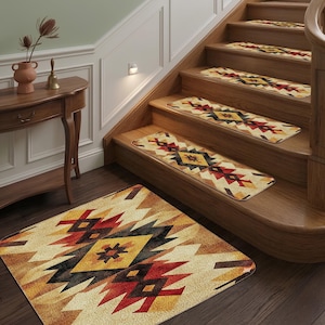 May include: A set of rectangular stair treads and a matching floor rug featuring a geometric pattern in shades of red, black, yellow, and cream. The textile pieces have rounded corners and are arranged on wooden stairs and the adjacent floor area.
