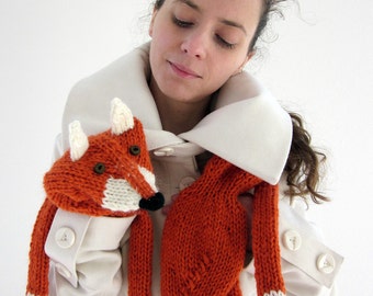 Hand knit fox scarf in red orange with polymer clay buttons, with ears and paws in white.