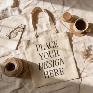 White Tote Bag Mockup — Top View Flat Lay with Coffee, Beige Minimal Scene, PSD Template